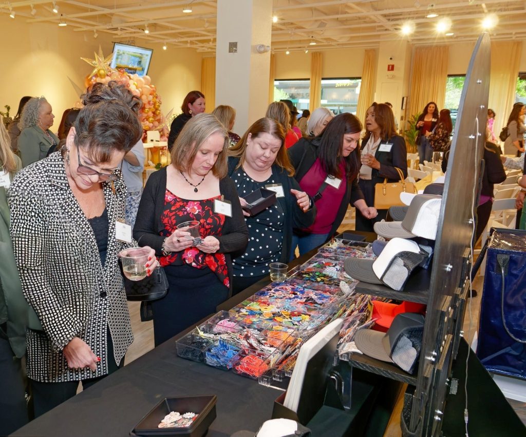 Guests selecting hats and embellishments at a mobile Las Vegas hat bar